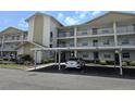 Condo exterior view featuring covered parking and multiple balconies on a sunny day at 7201 29Th Avenue W Dr # 306, Bradenton, FL 34209
