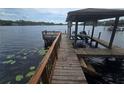 Dock with jet skis provides direct access to the lake, perfect for water activities at 7732 N Mobley Rd, Odessa, FL 33556