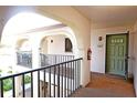 Balcony and front door of condo unit, with security features at 802 Capri Isles Blvd # 231, Venice, FL 34292