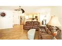 Open concept living room and kitchen area with stainless steel refrigerator at 802 Capri Isles Blvd # 231, Venice, FL 34292