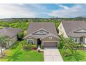 Aerial shot of the home displaying lush landscaping and a well-maintained lawn at 10708 52Nd E Ct, Parrish, FL 34219