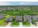 Aerial view showcasing the community layout with ponds and tree coverage at 10708 52Nd E Ct, Parrish, FL 34219