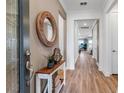Inviting entryway with hardwood floors, decorative table and accent mirror at 10724 Spring Tide Way, Parrish, FL 34219