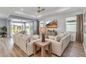 Spacious living room featuring hardwood floors, neutral decor and an abundance of natural light at 10724 Spring Tide Way, Parrish, FL 34219
