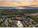 Aerial view of property surrounded by water on all sides with distant views of city and gulf at 11367 Perico Isle Cir, Bradenton, FL 34209