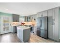 Modern kitchen with stainless steel appliances, gray cabinets and a center island with quartz countertops at 116 Vista Hermosa Cir # 204C, Sarasota, FL 34242