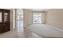 Open living space with tile flooring, leading to an outdoor patio with lake views at 12007 Clubhouse Dr, Lakewood Ranch, FL 34202