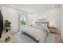 Calm bedroom with a comfortable bed, soft lighting, and a view of the neighborhood at 204 Eagleston Ln, Lakewood Ranch, FL 34240