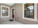 Welcoming front porch with two windows and a decorative front door at 229 Alento Ct, Nokomis, FL 34275
