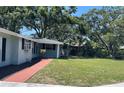 View of the home's front lawn with lush green grass and mature trees, creating a serene and inviting outdoor space at 236 Davis Blvd, Sarasota, FL 34237