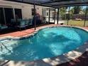 Inviting in-ground pool with brick paver surround and screened lanai, perfect for outdoor relaxation and entertaining at 236 Davis Blvd, Sarasota, FL 34237