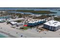 Stunning aerial view of a beachfront condo with beach access and a tiki hut at 2400 N Beach Rd # 1, Englewood, FL 34223
