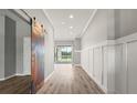 Inviting hallway featuring custom barn door and views of outdoor scenery at 2808 124Th E Ave, Parrish, FL 34219