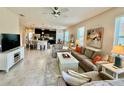 Open-concept living room with tile floors and a view of the kitchen with a large island and bar seating at 3120 Oriole Dr # 101, Sarasota, FL 34243