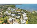 An aerial view showcases waterfront condos surrounded by lush landscaping and beautiful bodies of water at 3430 77Th W St # 103, Bradenton, FL 34209