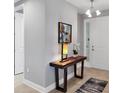 Bright entryway featuring a decorative table with modern lamp and art, adjacent to the front door at 3430 77Th W St # 103, Bradenton, FL 34209