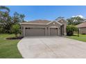 Charming single-story home with a well-manicured lawn and a convenient three-car garage at 4119 101St E Ave, Parrish, FL 34219