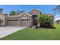Charming single-story home with a well-manicured lawn and a convenient three-car garage at 4119 101St E Ave, Parrish, FL 34219