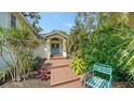 Beautiful blue double front doors with covered entryway and tropical landscaping at 4514 Trails Dr, Sarasota, FL 34232