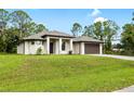 Charming one-story home boasts a contemporary design with a large lawn and modern driveway at 4661 Forlano Cir, North Port, FL 34291