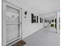 Exterior view of white condo building with a white front door and black shutters at 4745 Independence Dr # 4745, Bradenton, FL 34210