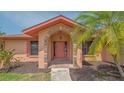 Charming front entrance featuring a brick archway, well-kept landscaping, and unique architectural details at 5004 32Nd E St, Bradenton, FL 34203