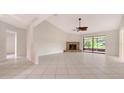 Spacious living room featuring tile floors, a cozy fireplace, and sliding glass doors to the lanai at 5004 32Nd E St, Bradenton, FL 34203