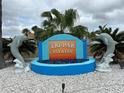 Community entrance featuring a decorative dolphin fountain and the Tri-Par Estates sign at 5268 Boca Raton Ave, Sarasota, FL 34234