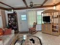 Bright living room with ceiling fan, neutral decor, and plenty of natural light at 5268 Boca Raton Ave, Sarasota, FL 34234
