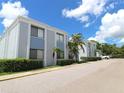 Exterior view of the condo building, showcasing well-maintained grounds and ample parking at 5310 26Th W St # 902, Bradenton, FL 34207