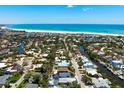 Aerial view of a beach house with a pool, surrounded by lush greenery and located near the beach at 5385 Avenida Del Mare, Sarasota, FL 34242