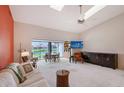 Bright living room with high ceilings, carpet flooring and a view of the water at 6096 Wilshire Blvd # 9, Sarasota, FL 34238