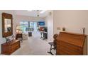 Bright living room with carpet flooring, skylights, ceiling fan, and a view of the water at 6096 Wilshire Blvd # 9, Sarasota, FL 34238