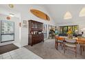 Open-concept living and dining area with tile entry, vaulted ceilings and a view to the balcony at 6204 Midnight Pass Rd # 201, Sarasota, FL 34242