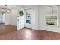 Bright foyer with tile flooring, wreath on front door, and natural light streaming through the window at 635 N Jefferson Ave # 635, Sarasota, FL 34237