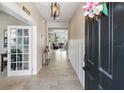 Welcoming foyer with tile flooring, stylish light fixture, and a view into the living area at 6356 Mighty Eagle Way, Sarasota, FL 34241