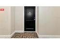 A close-up of the unit's front door, set against the neutral hallway, with patterned carpeting at 101 S Gulfstream Ave # 16C, Sarasota, FL 34236