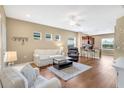 Sunlit living room featuring hardwood floors and open-concept design to the kitchen at 11835 Crawford Parrish Ln, Parrish, FL 34219