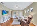 Bright and airy living room with hardwood floors and cozy seating arrangement at 11835 Crawford Parrish Ln, Parrish, FL 34219