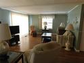 Comfortable living room featuring hardwood floors, TV and soft decor at 1212 45Th E Ave, Ellenton, FL 34222