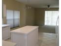 Open kitchen featuring tile floors and an island with views of the living room at 12301 Mosswood Pl, Lakewood Ranch, FL 34202