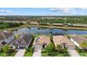 Scenic aerial view showcasing the backyard lake of homes with tile roofs and lush landscaping at 17018 Blue Ridge Pl, Bradenton, FL 34211