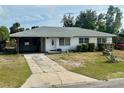 Cozy single-story home with a covered carport and a concrete driveway at 1905 Yale Ave, Bradenton, FL 34207