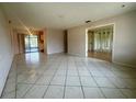 Open-concept living room with tile flooring, and sliding glass doors at 1905 Yale Ave, Bradenton, FL 34207