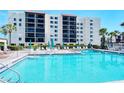 Relaxing pool area with lounge chairs and umbrellas, perfect for a resort-style living at 2045 Gulf Of Mexico Dr # M1-302, Longboat Key, FL 34228