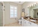 Bathroom featuring tiled floors, granite counters, and a glass-enclosed shower at 2067 Tocobaga Ln, Nokomis, FL 34275