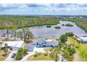 Expansive aerial view of the property showcasing waterfront views and lush greenery for a peaceful setting at 2100 Oyster Creek Dr, Englewood, FL 34224