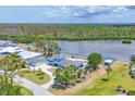 Charming blue home featuring waterfront access and outdoor pool for luxury and relaxation at 2100 Oyster Creek Dr, Englewood, FL 34224