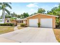 Beautiful single-story home showcases a spacious driveway and a well-maintained front yard at 2726 Silver King Way, Sarasota, FL 34231