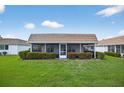 Screened-in porch surrounded by manicured hedges and greenery at 2733 Riverbluff Pl # V57, Sarasota, FL 34231